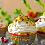 Festive, fragrant & delicious Pistachio Cranberry Orange Muffins! Orange scented, studded with juicy, jewel red cranberries & crunchy, vibrantly green pistachios & finished with a swirl of vanilla cream. 