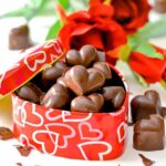 a heart shaped tin full of vegan chocolate caramels