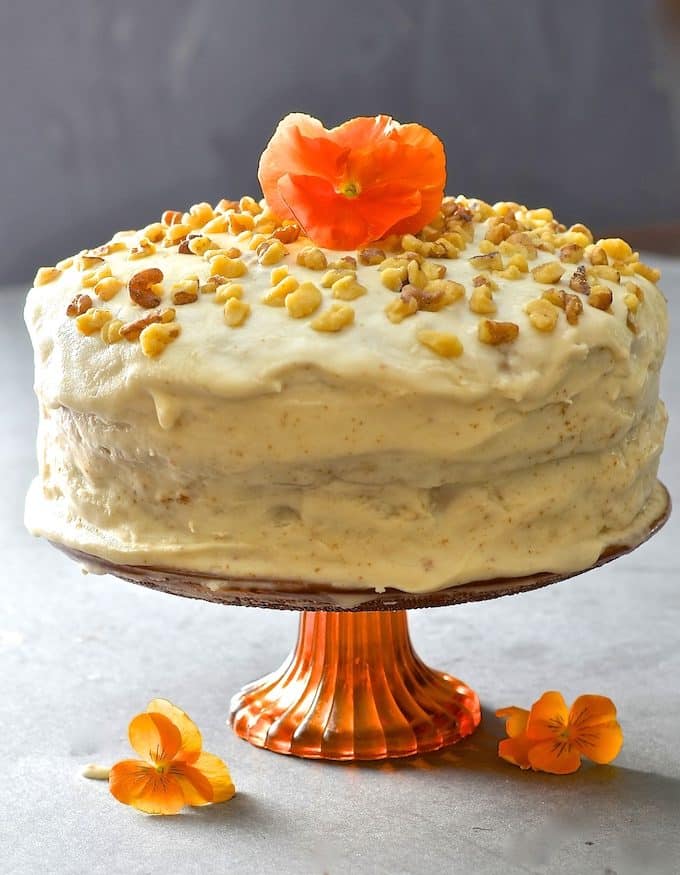 Tender, moist nutty sponge sandwiched together with creamy maple infused frosting. Completely dairy, egg & oil free yet perfectly sweet & decadent, this maple walnut cake is total perfection!
