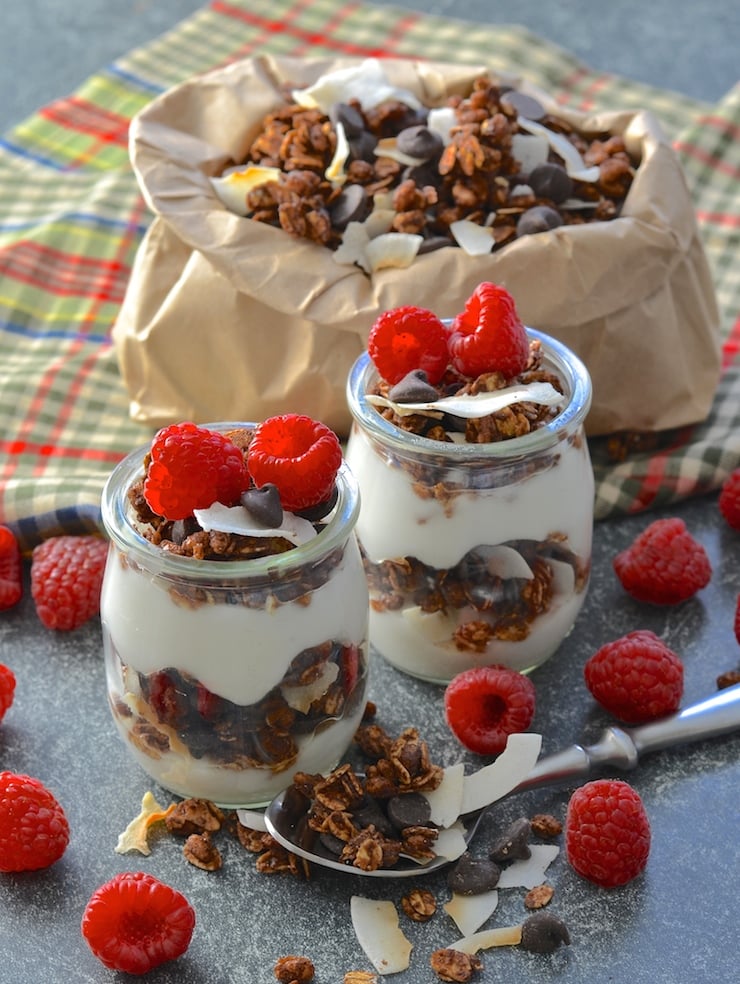double chocolate coconut vegan granola with yogurt and raspberries in small jars