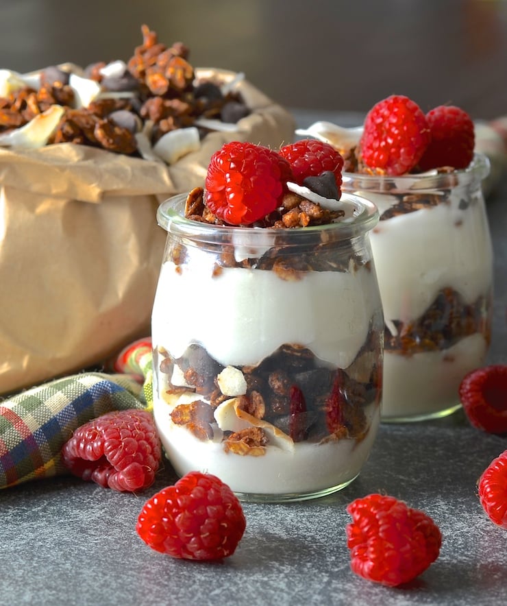 Double Chocolate Coconut Vegan Granola layered up with vegan yogurt and fresh raspberries
