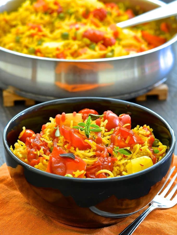 This One-Pot Spicy Vegetable Rice is our go to favourite mid-week dinner. 3o minutes & one pot is all that is standing between you & a big bowl full of deliciously spiced, flavourful rice studded with sweet, soft veggies.