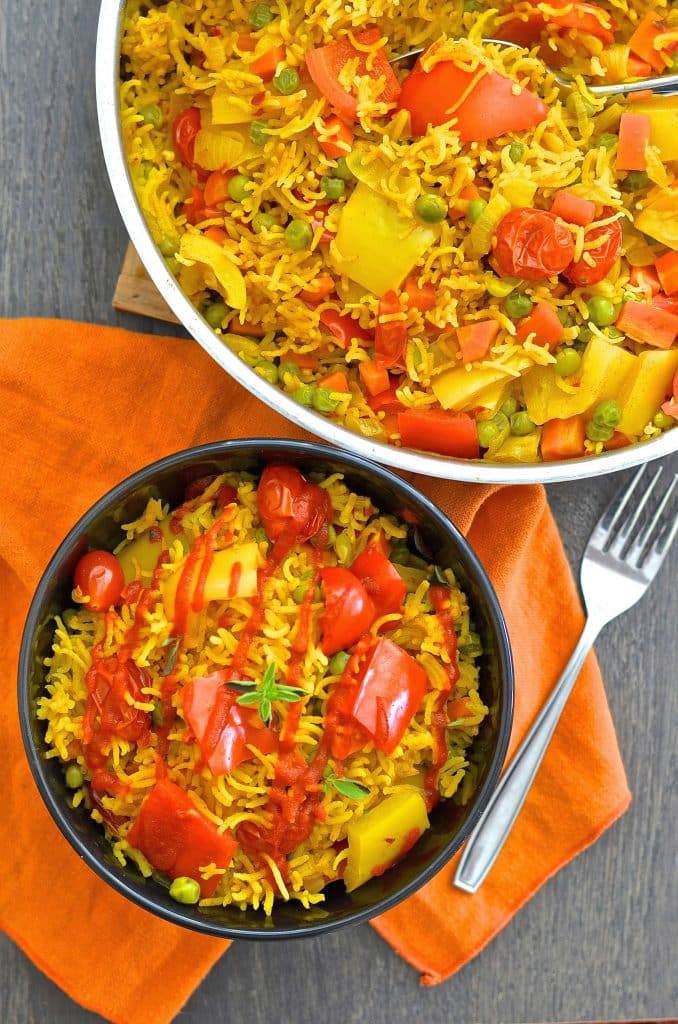 This One-Pot Spicy Vegetable Rice is our go to favourite mid-week dinner. 3o minutes & one pot is all that is standing between you & a big bowl full of deliciously spiced, flavourful rice studded with sweet, soft veggies.