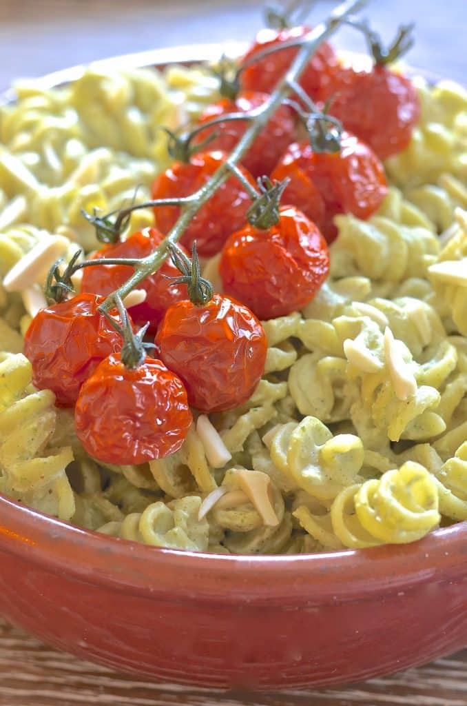 A simple but incredibly delicious, super creamy Vegan Pesto Pasta Salad topped with juicy, sweet, oven roasted tomatoes. It has just 5 ingredients & is ready in the time it takes to roast the tomatoes!