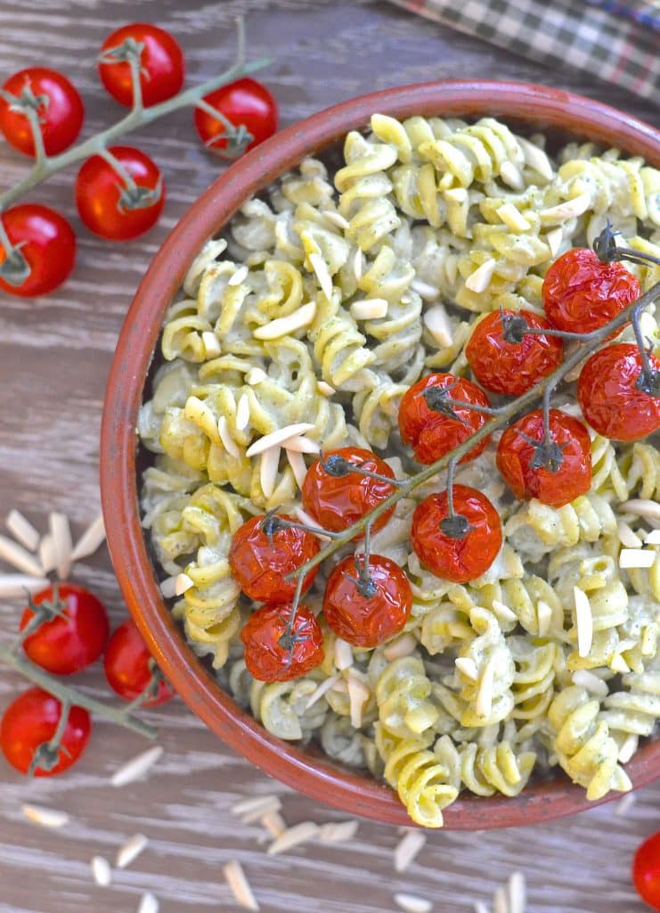 A simple but incredibly delicious, super creamy Vegan Pesto Pasta Salad topped with juicy, sweet, oven roasted tomatoes. It has just 5 ingredients & is ready in the time it takes to roast the tomatoes!