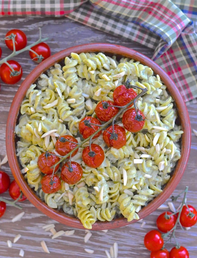 A simple but incredibly delicious, super creamy Vegan Pesto Pasta Salad topped with juicy, sweet, oven roasted tomatoes. It has just 5 ingredients & is ready in the time it takes to roast the tomatoes!