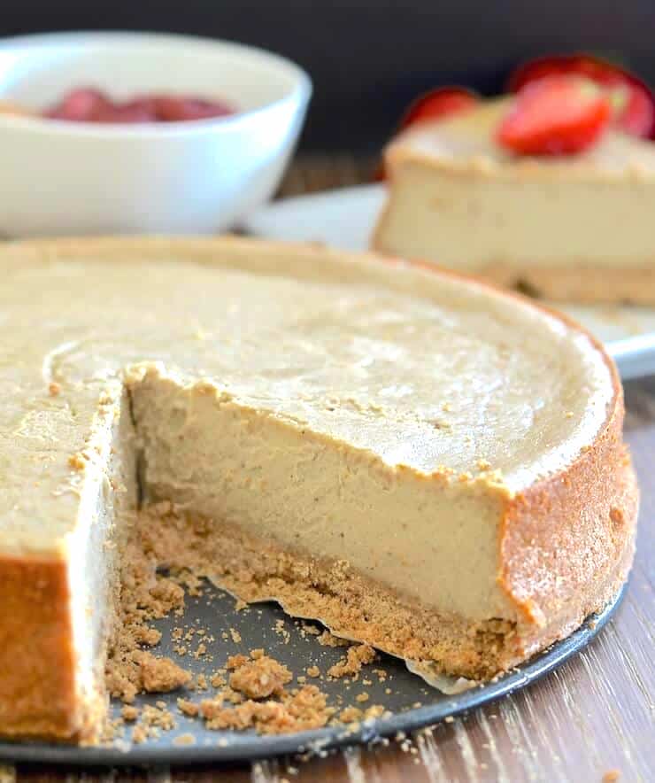 A Baked Vegan New York Cheesecake with a slice taken out