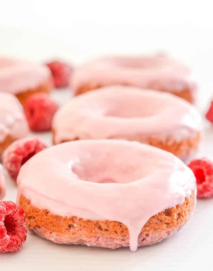 Soft & fluffy baked Vegan Raspberry Donuts with a sweet, smooth, pretty in pink glaze. All infused with sweet raspberry flavour & so delicious! Don't worry if you don't have a donut pan because they can also be made as muffins. 