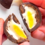 A vegan creme egg cut in half. Inside visible.