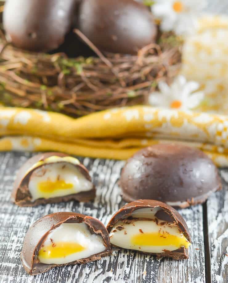 Homemade Vegan Cadbury's Creme Eggs cut open with fondant inside showing. 