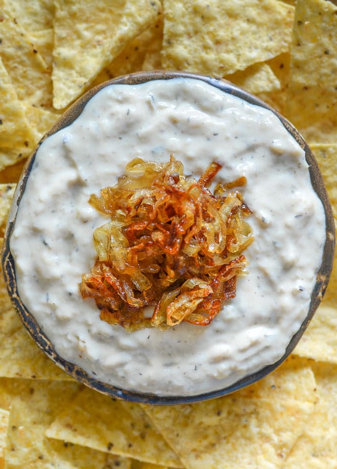 creamy onion garlic dip close up shot with caramelized onions on top 