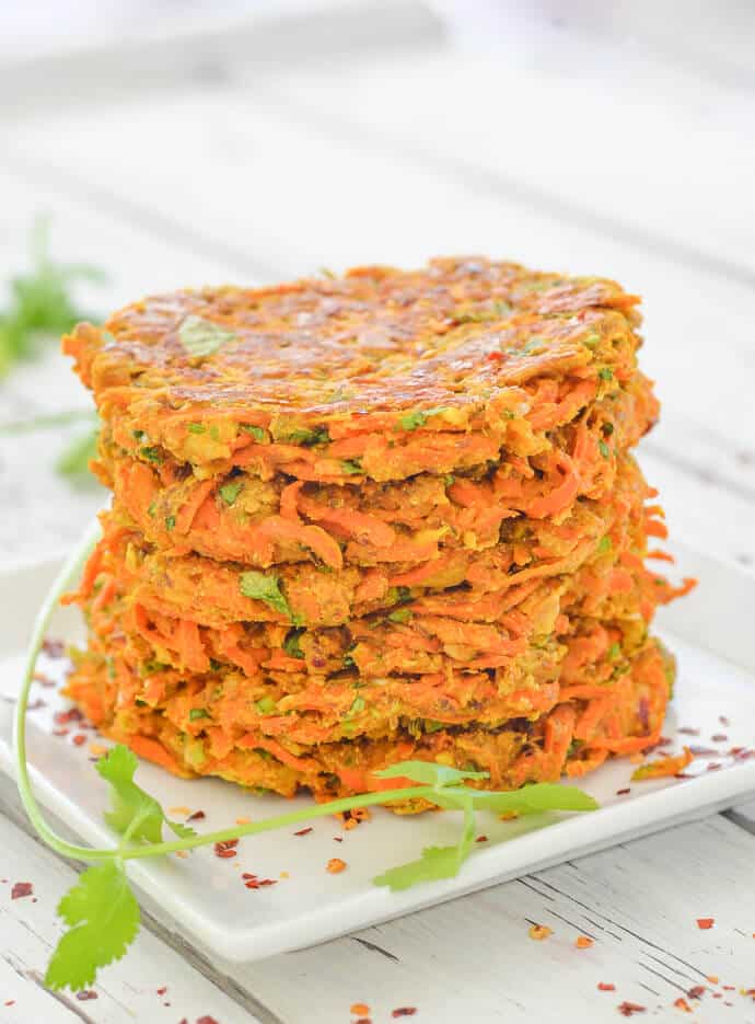 Stacked Curried Carrot Fritters with cilantro garnish