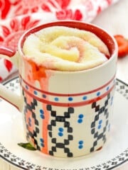 a strawberry sweet roll in a mug