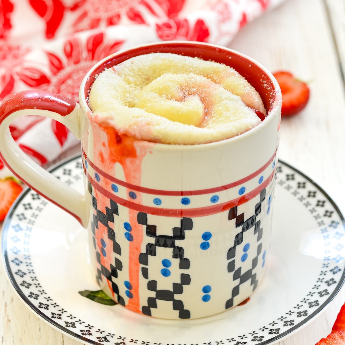 a strawberry sweet roll in a mug