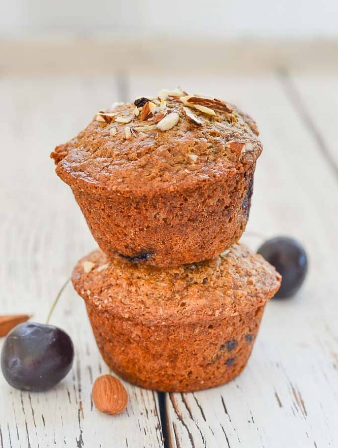 Buttery, moist, soft Almond Cherry Muffins stacked on top of each other