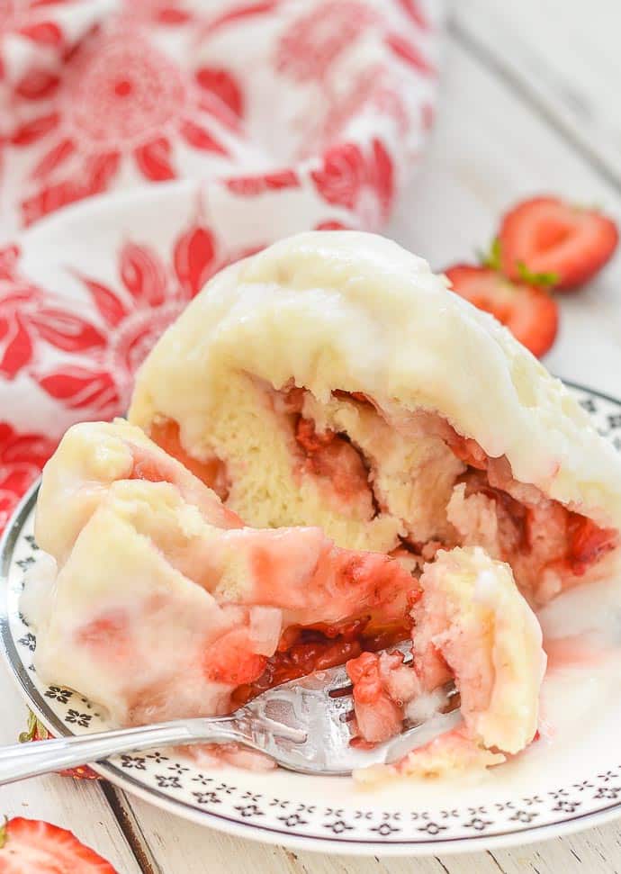 Strawberry Sweet Roll Mug Cake cut open on a plate