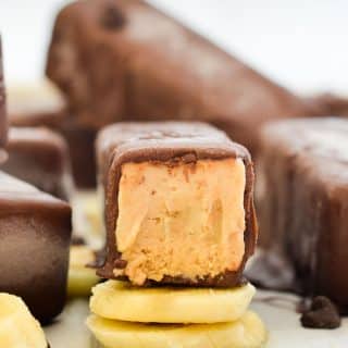Slightly melty Super Easy Banana Peanut Butter Ice Cream bar resting on a pile of sliced banana