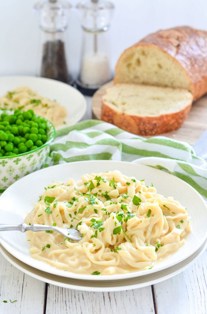 Skinny Fettuccine Cauliflower Alfredo scattered with parsley on a plate