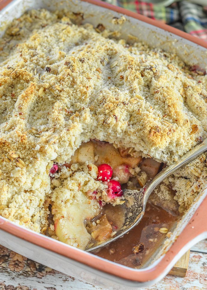 Cranberry Apple Pear Vegan Crumble with a serving taken out. Fruity inside visible