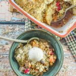 Overhead shot of Cranberry Apple Pear Vegan Crumble served up in a bowl with casserole full of crumble next to it