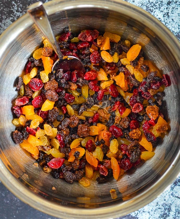 dried fruit in a bowl steeped in brandy in preparation for making a Vegan Christmas Pudding 