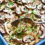 easy Oven Baked Garlic Mushroom Rice being served up with a spoon