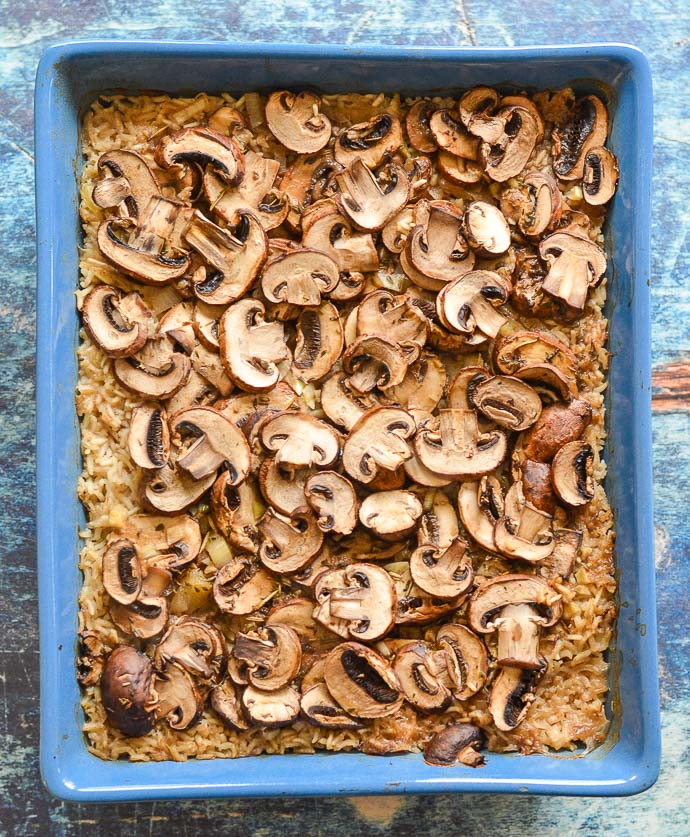 Easy Oven Baked Garlic Mushroom Rice cooked in a blue dish