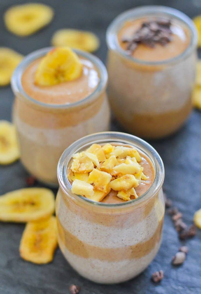 chia seed pudding in small tulip shaped clear jars and topped with date caramel