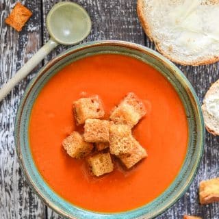 A bowl of Instant Pot Tomato Soup topped with golden croutons