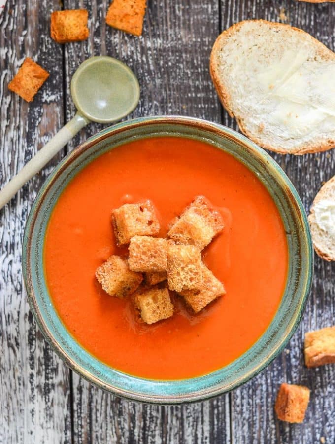 A bowl of Instant Pot Tomato Soup topped with golden croutons