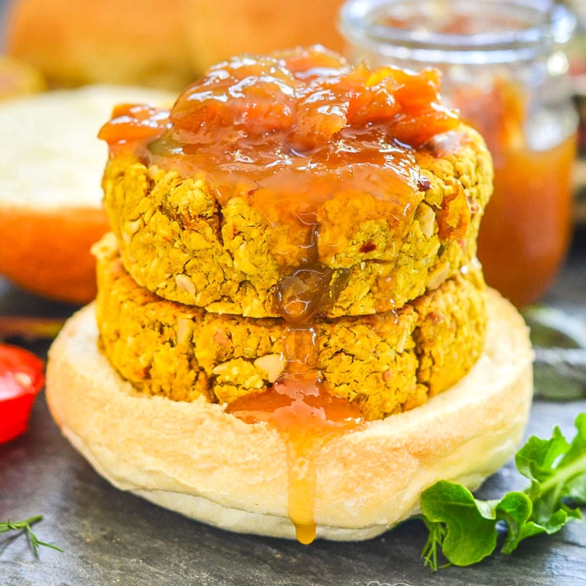 stacked curried chickpea burgers drizzled in mango chutney.