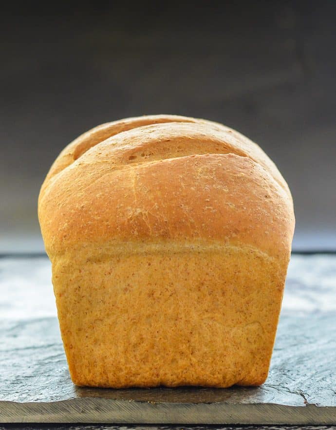 freshly baked easy whole wheat bread on a slate board