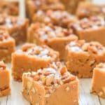 a square of Salted Maple Pecan Vegan Fudge topped with pecans and sea salt flakes