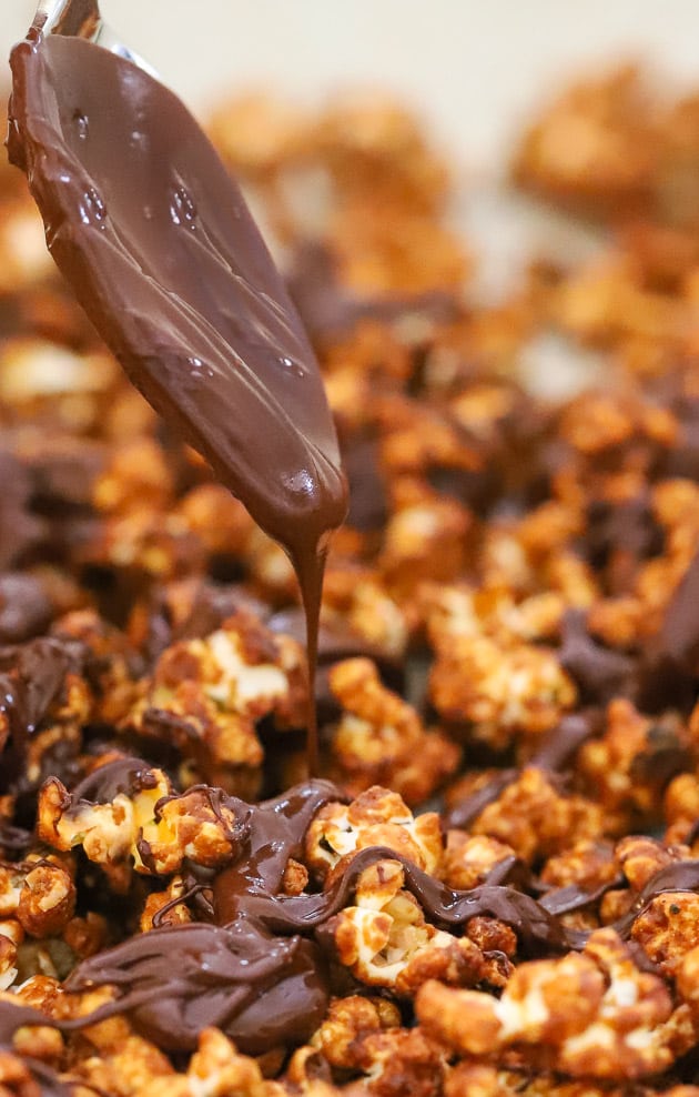 melted chocolate being drizzled on popcorn