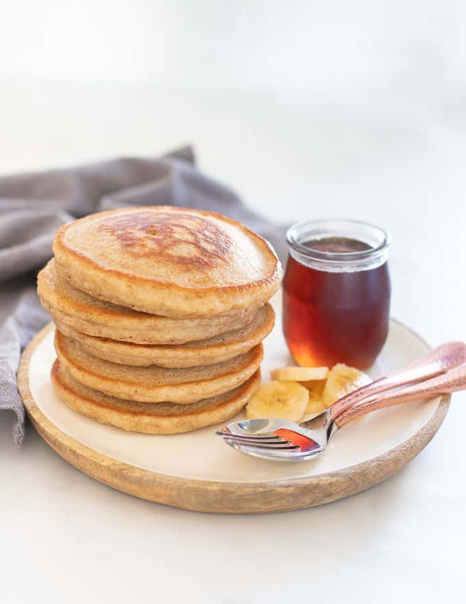 Fluffy Vegan Bananan Pancakes with sliced banana and maple syrup