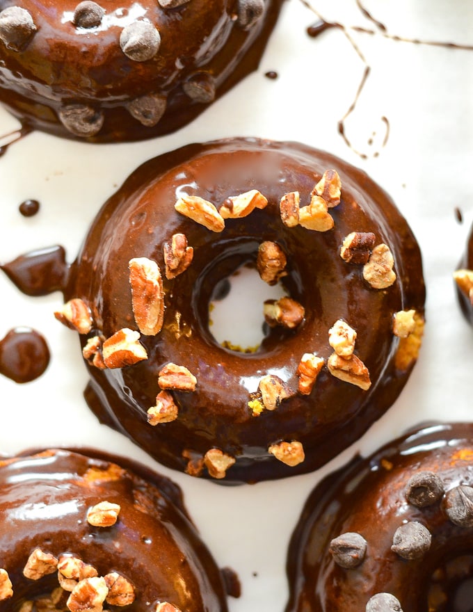 Chocolate Pumpkin Donuts with nut sprinkles taken from above on a white backdrop 