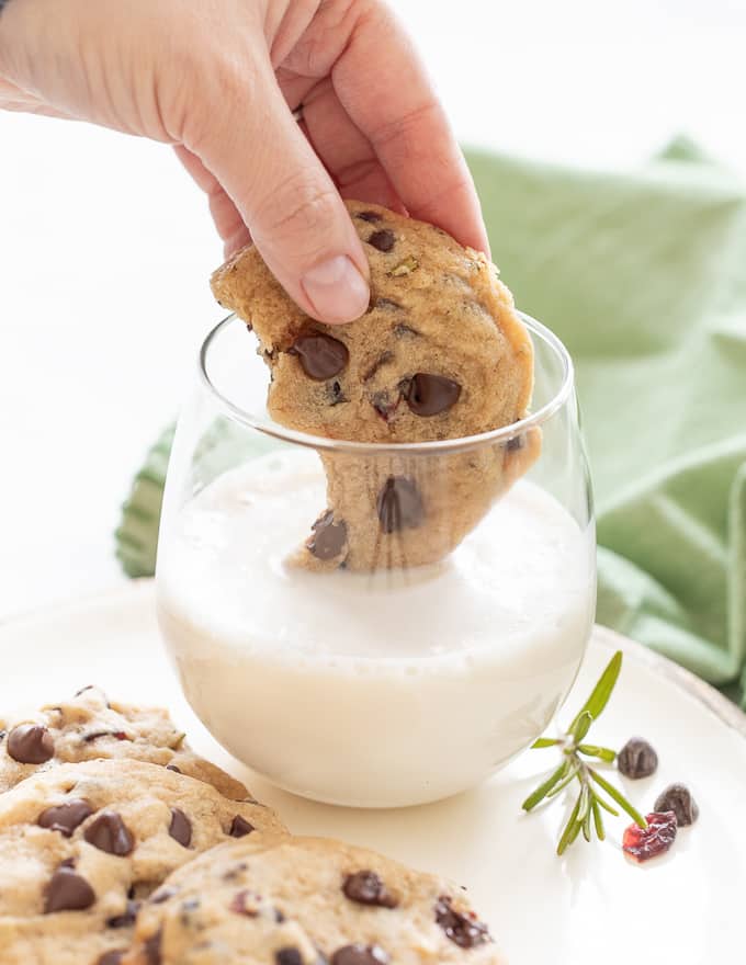 Vegan Chocolate Chip Cookie dipped in a glass of almond milk 