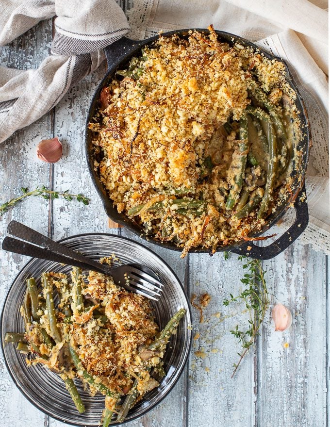 A made-from-scratch Vegan Green Bean Casserole with tender green beans baked up in a deliciously creamy mushroom sauce, and topped with crispy, golden, buttery breadcrumbs and tangles of caramelized onions. This really is the ultimate way to eat green beans!