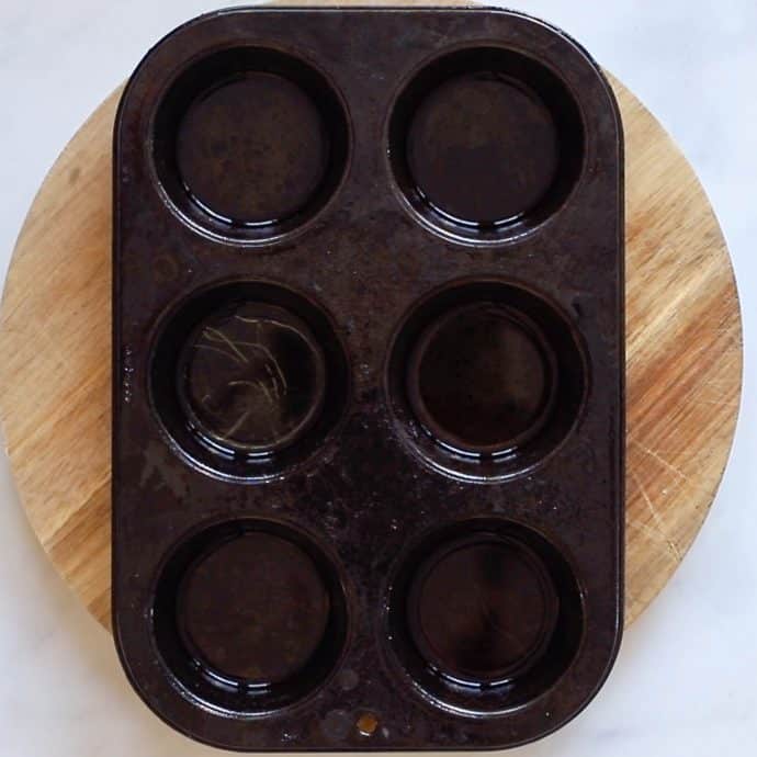 Hot oil in a muffin tin - ready to make Vegan Yorkshire Puddings