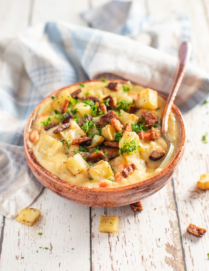 Vegan Potato Soup in a bowl with tempeh bacon, roast potatoes and parsley