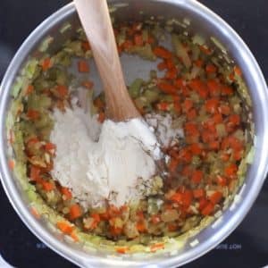 stirring flour into base of vegan potato soup