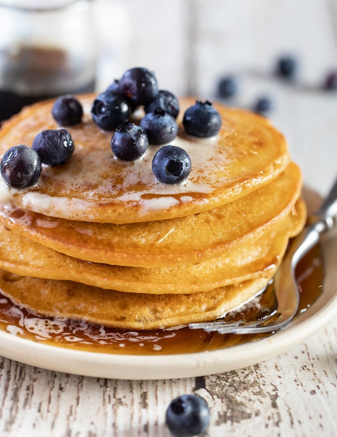 A stack of Vegan Gluten Free Pancakes with fresh blueberries