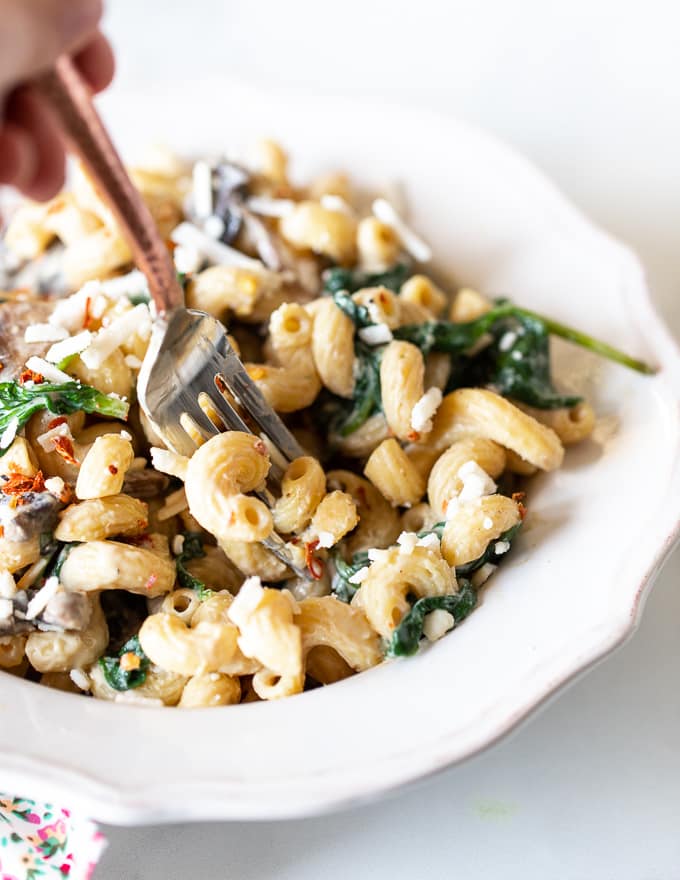 someone taking a forkful of creamy vegan mushroom pasta 