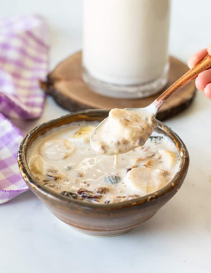 A bowl of granola with milk in a bowl