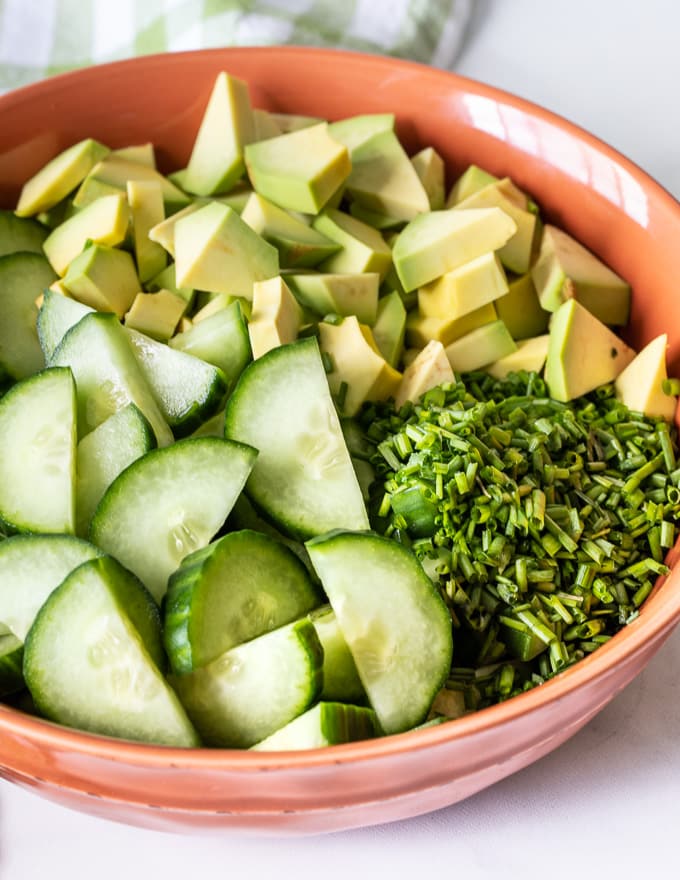 cucumber, avocado and fresh dill in a bowl