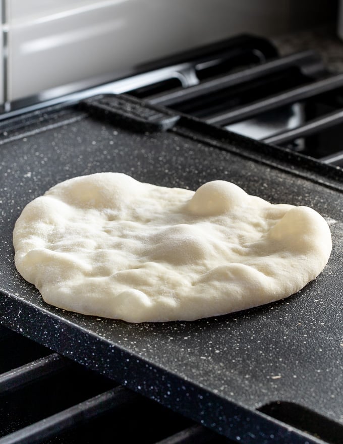 bubbles appearing in a cooking flatbread