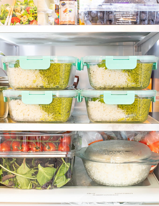 stacked vegan meal prep containers in the fridge 