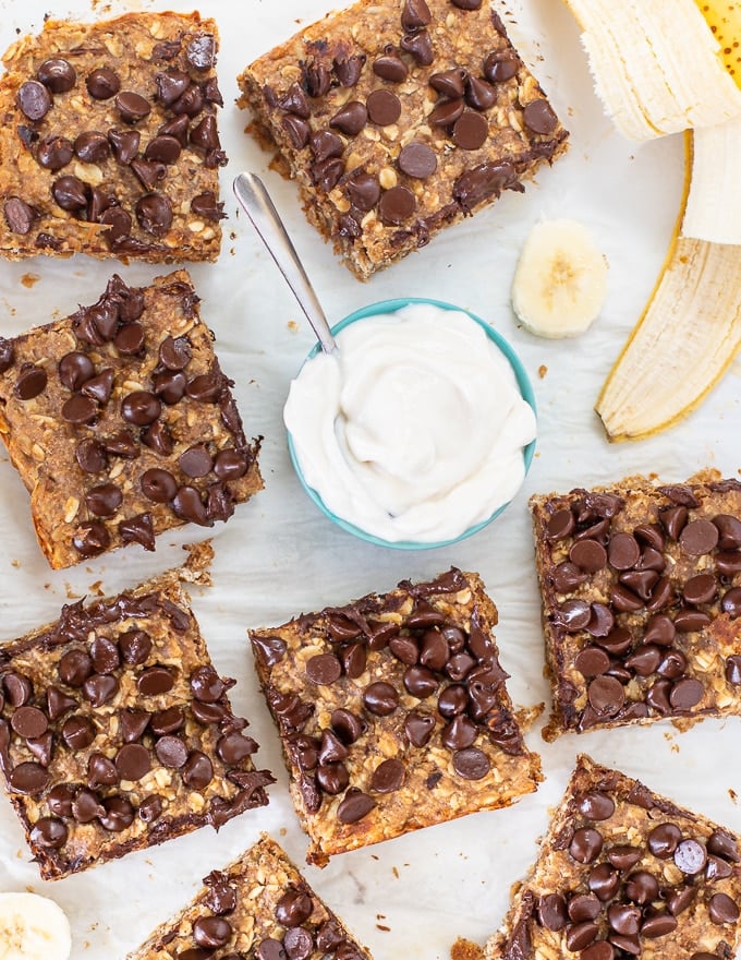 healthy breakfast bars with a bowl of vegan yogurt and sliced banana