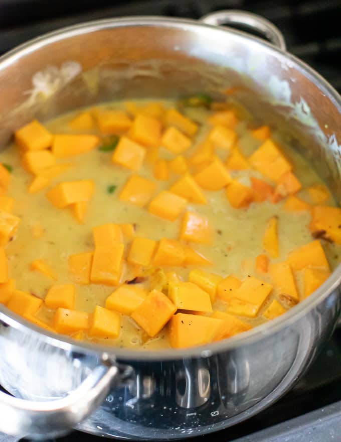 butternut squash being added to easy butternut squash curry