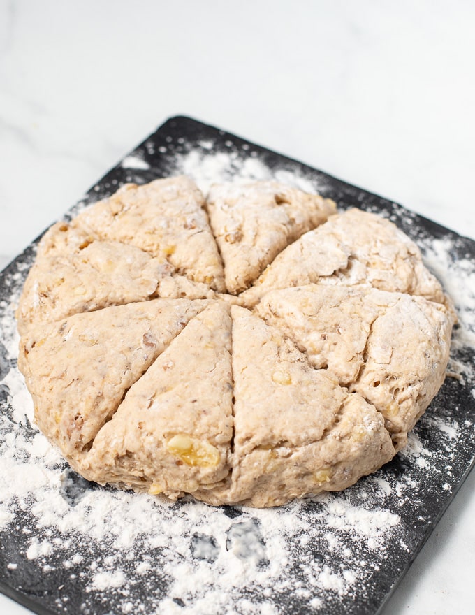 vegan banana scone dough patted into a round and cut into 8 wedges